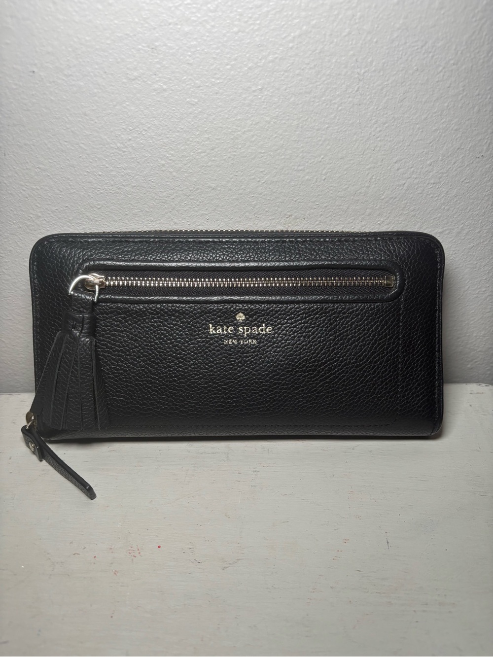 kate spade black pebbled leather zip-around wallet with tassel